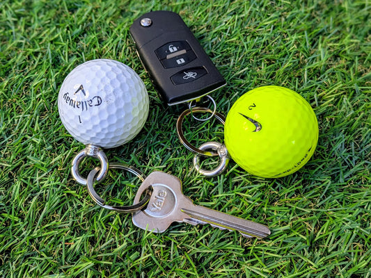 close up of actual upcycled golf balls as key rings used for car keys and house keys